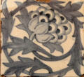 Artichoke ceramic tile by William Morris or William De Morgan at Morris Gallery. London, United Kingdom.