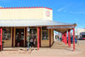 Covered wooden sidewalks surround Quong Kee's Can Can restaurant building. Tombstone, AZ.
