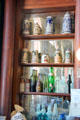 Collection of beer steins & bottles on bar at Bird Cage Theatre. Tombstone, AZ.