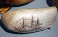 Scrimshaw of sailing ship on whale's tooth in Maritime Museum. Monterey, CA.