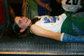 Student tries a bed of nails in California Science Center. Los Angeles, CA.