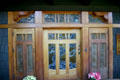 Gamble house front door with leaded glass window of tree. Pasadena, CA