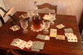 Card table with decanter & glasses at Davis House Museum. San Diego, CA.