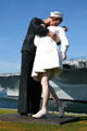 Unconditional Surrender giant sculpture of sailor kissing nurse on V-J day by Seward Johnson after famous photograph in park beside Midway carrier museum. San Diego, CA.