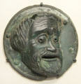 Greek bronze roundel with comic mask from South Italy at Getty Museum Villa. Malibu, CA.