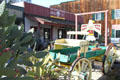 Cactus & buckboard before frontier-style commercial building. Temecula, CA.