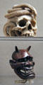 Netsuke of skull with two snakes & Netsuke of Hannya mask from Japan at Asian Art Museum. San Francisco, CA.