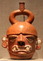 Moche earthenware portrait vessel of fanged deity from Peru at de Young Museum. San Francisco, CA.