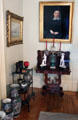 Parlor side table with luster candlestick & bric-a-brac under paintings at Pardee Home Museum. Oakland, CA.