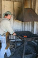 Blacksmith working at forge of Clear Creek History Park. Golden, CO.