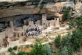 Visitors examine one of round Kiva ceremonial chambers at Cliff Palace in Mesa Verde National Park. CO.