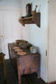 Storage chest with wooden under wall shelf with clock at Baca Adobe House. Trinidad, CO.