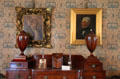 Family portraits over Empire-style sideboard with knife boxes & urns in dining room at Hill-Stead Museum. Farmington, CT.