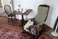 Upholstered rocking chair with tea table at Strong House. Windsor, CT.
