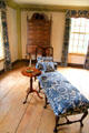 Chaise lounge with candle table in southeast bedroom at Silas Deane House. Wethersfield, CT.