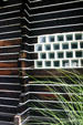 Detail of redwood walls & glass block windows of Boothe Brothers' Technocratic Cathedral. Stratford, CT.