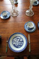 Porcelain table setting with willowware-style pattern at Judson House. Stratford, CT.