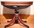 Mahogany card table supported by carved eagle from New York at Yale University Art Gallery. New Haven, CT.