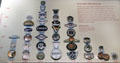 Collection of automobile maker radiator emblems by year at National Museum of American History. Washington, DC.