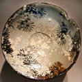 Japanese stoneware dish with design of pines in snow by Kiyomizu Rokubei II at Smithsonian Freer Gallery of Art. Washington, DC.