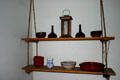 Swinging shelves with glass & pottery objects in Colonial Spanish Quarter Museum. St Augustine, FL.
