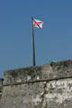 Burgundy Cross flag of first Spanish Colonial period in Florida over Castillo de San Marcos. St Augustine, FL.