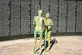 Skeletal statues in front of wall with names of victims at Holocaust Memorial. Miami Beach, FL.