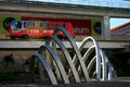 Arched sculpture Rhythm of the Train by Joan Lehman on Metromover right-of-way. Miami, FL.