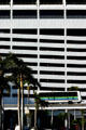 Miami Metromover car against downtown parking structure. Miami, FL.