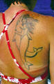 Cruise hostess with dolphin tattoo off Kona coast. Big Island of Hawaii, HI.