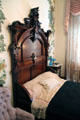 Headboard of walnut bedroom set from Ogden Hotel of Council Bluffs at Dodge House. Council Bluffs, IA.