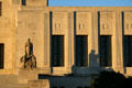 The Patriots statue beneath row of pioneer carvings at Louisiana State Capitol in light of sunset. Baton Rouge, LA.