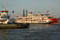 Natchez steamboat passes Crescent City Connection ferry on Mississippi River. New Orleans, LA.