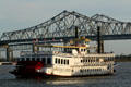 Creole Queen steamboat against Crescent City Connection Bridge. New Orleans, LA.