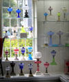 Collection of colored glass blown & cut lamps most by Boston & Sandwich Glass Co. at Sandwich Glass Museum. Sandwich, MA.