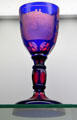 Engraved Ruby Stained Goblet by Boston & Sandwich Glass Co. at Sandwich Glass Museum. Sandwich, MA.