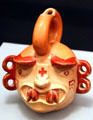Moche stirrup-spout vessel of fanged god with figure eight ears from Peru at Peabody Museum. Cambridge, MA.