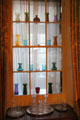 Dining room window cupboard with collection of early glass at Nichols House Museum. Boston, MA.