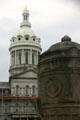Facade of Baltimore City Hall behind canon-shaped entrance pillar. Baltimore, MD.