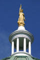 Golden figure of Wisdom with lantern by W. Clark Noble on State Capitol. Augusta, ME.
