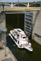 Tour boat emerging from Upper Lock on Mississippi River. Minneapolis, MN.