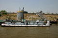 Mississippi River barge with storage tanks beyond. St Louis, MO.