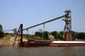 Mississippi River barge with conveyor belts beyond. St Louis, MO.