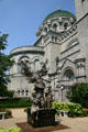 Angel of Harmony sculpture by Wiktor Szostalo & side facade of Saint Louis Cathedral. St Louis, MO.