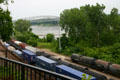 Freight train runs along Missouri River past U.S. 54 Bridge. Jefferson City, MO.