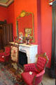 Fireplace flanked by armchairs at Vaile Mansion. Independence, MO.