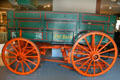 Painted horse-drawn freight wagon lettered The Bain at Museum of the Rockies. Bozeman, MT.