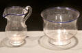 Clear glass creamer & bowl with blue glass rims prob. New England at Museum of American Glass. Milville, NJ.