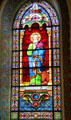 Evangelist St Luke with bull stained glass window in St Francis Cathedral. Santa Fe, NM.