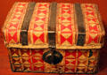 Leather petecas travel chest decorated with red bayeta wool from Mexico at New Mexico History Museum. Santa Fe, NM.